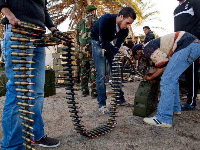 Libyan militia members who are now part of the forces against Libyan leader Moammar Gadhafi organize ammunition at a military base in Benghazi, in eastern Libya, on Monday, Feb. 28, 2011. (The Associated Press)