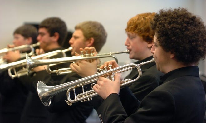 Shawnee High School jazz band members (from right) Kevin Goldberg, Ian Bakanans, and Kevin Talbot practice on Friday at the school in Medford, N.J. The band will be competing at the Berklee College of Music High School jazz festival this weekend in Boston.
