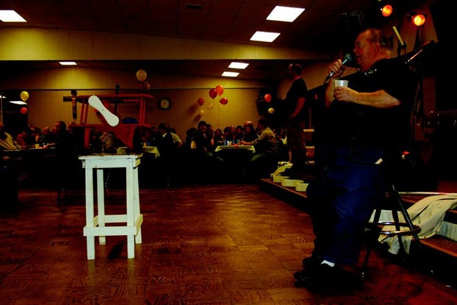 Merle Berden asks for bids on a children’s toy during the annual Cheboygan County Fireman’s Association Dinner, Dance and Auction Saturday at the Knights of Columbus Hall in Cheboygan. About 400 people attended the event, which raises money for training and equipment for all fire departments within the county.