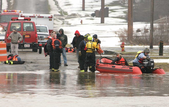 Massillon firefighters rescue residents from a flooded home on Kenyon Avenue.