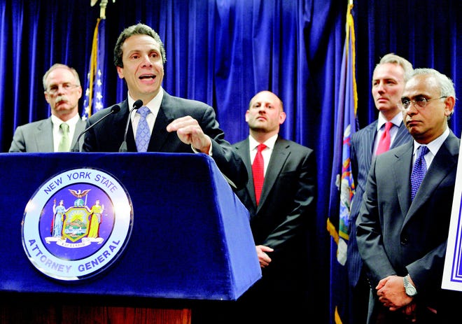 In this file photo of June 5, 2008, then New York state Attorney General Andrew Cuomo, second from left, announces an agreement a New York news conference with Wall Street's three major credit rating agencies to overhaul how they evaluate investments backed by risky mortgage debt. Participants include: Fitch Ratings President & CEO Stephen Joynt, left; N.Y. state Investor Protection Bureau Chief David Markowitz, third from left; Moody's Investors Service COO Michel Madelain; and Deven Sharma, right, president of Standard & Poor's. The mid-2008 agreements, obtained by The Associated Press after a Freedom of Information Law appeal, show that by the time Cuomo declared he had reined in the rating companies, and boosted his political arc toward becoming governor, the investment banks had already stopped pitching the risky securities. (AP Photo/Richard Drew, File)