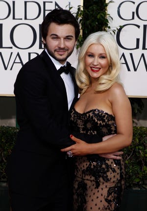 In this Jan. 16, 2011 file photo, Christina Aguilera, right, arrives with Matthew Rutler for the Golden Globe Awards in Beverly Hills, Calif. Aguilera was arrested early Tuesday, March 1, 2011 near the Sunset Strip on suspicion of being drunk in public but will not be prosecuted, authorities said. The driver, Matthew Rutler, 25, was arrested on suspicion of driving under the influence and jailed on $5,000 bail, sheriff's spokesman Steve Whitmore said.