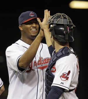 Cleveland starting pitcher Fausto Carmona (left) is congratulated by catcher Lou Marson after the Indians defeated the first place Minnesota Twins, 2-0, Friday in Cleveland.