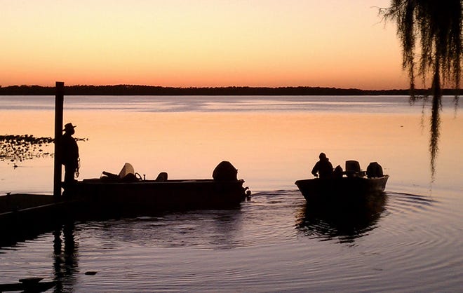 Fishermen leave Lake Lochloosa at sunset on Feb. 13, 2011.