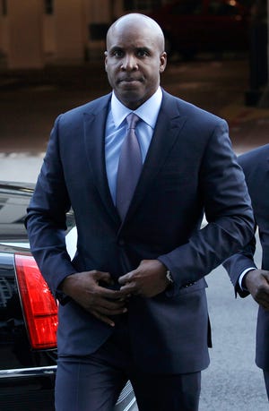 Former baseball player Barry Bonds arrives at a federal courthouse in San Francisco on Tuesday. For a third time, Bonds entered a plea of not guilty after prosecutors amended the charges filed against him.