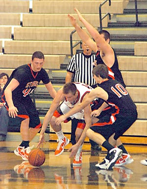 Sturgis’ Cody Jansen (left), Drake Miller (above) and Boe Savage (right) swarm a Portage Northern player Tuesday night.