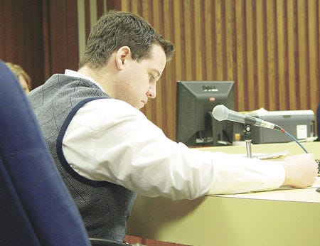 Defendant Douglas Stewart studies a paper Tuesday as attorneys have a brief bench conference with Circuit Judge Paul Stutesman.?It was Day 5 of Stewart’s trial.