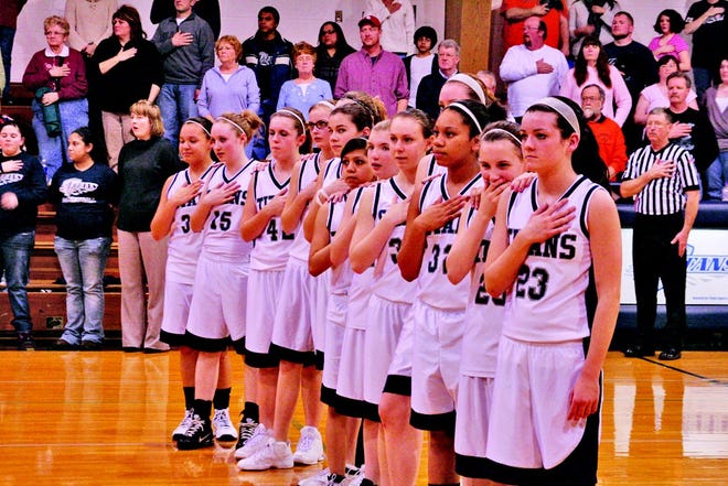 The MRJHS eighth grade girls basketball team stands at attention during the Pledge.