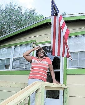 Coretta Tomblin stands proudly in front of her newly weatherized home. Contributed photo