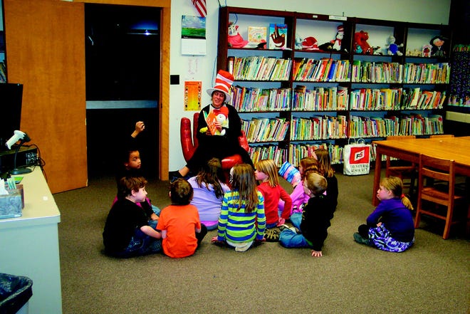Amy Quinn reads to children during the Parental Engagement Committee's first meeting. Meanwhile, their parent learned techniques to better teach them how to read.