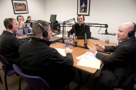 Scot Landry, host of "The Good Catholic Life" radio show, speaks to St. John's Seminary vice-rector Father Chris O'Connor, Deacon Mark Murphy, show producer Rick Heil and Deacon Kyle Stanton during a test broadcast March 1 at the Pastoral Center in Braintree.
