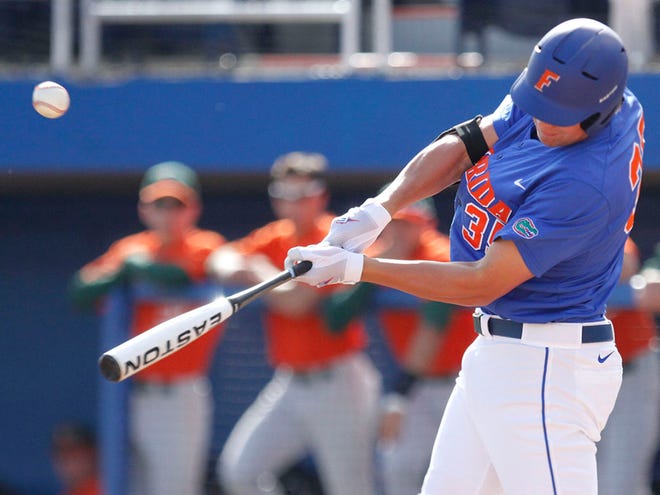 The University of Florida's Brian Johnson makes contact with the ball during a game against the University of Miami at McKethan Stadium in Gainesville. The Gators won 1-0 to win the weekend series against the Hurricanes. (Brad McClenny/Staff photographer)