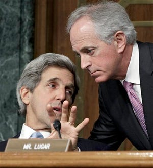 Senate Foreign Relations Committee Chairman John Kerry, D-Mass., left, confers with committee member Sen. Bob Corker, R-Tenn. on Capitol Hill in Washington, Wednesday, March 2, 2011, during the committee's hearing where Secretary of State Hillary Rodham Clinton testifies.