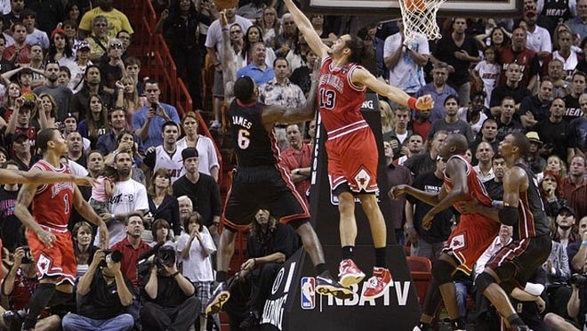 LeBron James puts up a last-second shot attempt over the outstretched arms of Chicago's Joakim Noah. The shot bounced off to the right. Dwyane Wade corraled the rebound and got off a final shot, but it fell short and the Bulls won 87-86 on Sunday, March 6, 2011.