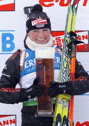 Andrea Henkel, of Germany, holds a large mug of Erdinger no-alcohol beer after winning the women’s sprint race last month at the biathlon World Cup in Fort Kent, Maine.