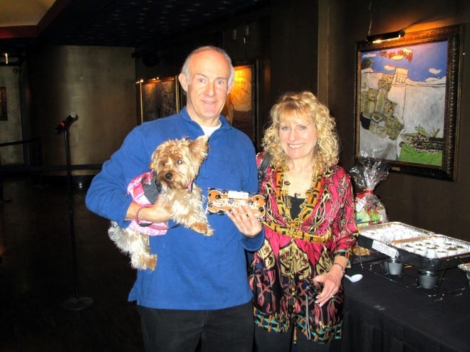 Mark and Carol Yanche of Staten Island, N.Y., let their dog, Jamie, sample some of the dog treats provided by Jake’s Dog House at the Thursday night reception for guests taking advantage of the Showboat Atlantic City’s new policy of allowing its hotel guests to have their dogs stay with them in their rooms. Showboat is the first casino in Atlantic City to provide the service