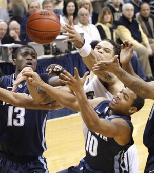 Pittsburgh's Gary McGhee, top center, and Villanova's Corey Fisher (10) and Mouphtaou Yarou (13) try for a rebound in the first half of the NCAA college basketball game, Saturday, March 5, 2011 in Pittsburgh. (AP Photo/Keith Srakocic)