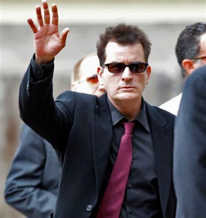 In a Aug. 2, 2010 file photo, Charlie Sheen waves as he arrives at the Pitkin County Courthouse in Aspen, Colo., for a hearing in his domestic abuse case. Warner Bros. Television says it has fired actor Charlie Sheen from the hit sitcom "Two and a Half Men."The studio that produces the CBS series said the decision was made after "careful consideration."