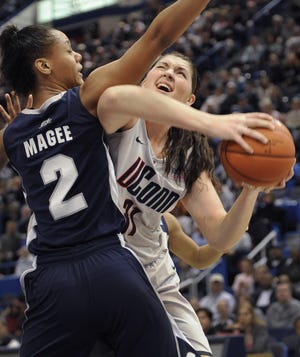 Connecticut's Stefanie Dolson, right, is fouled by Georgetown's Tia Magee during the first half of a quarterfinal NCAA college basketball game at the Big East Conference Championships in Hartford, Conn., Sunday, March 6, 2011.