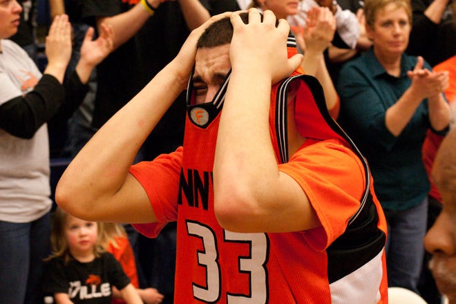 Xavier Grigg of Fennville is struck with emotion after the Blackhawks' win over Lawrence High School on Monday night at DeVos Fieldhouse.