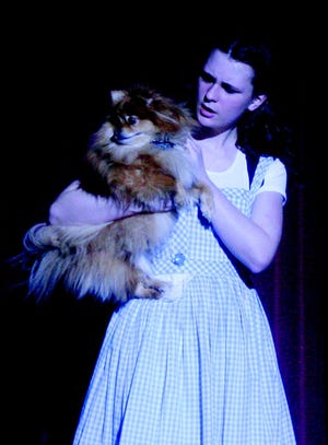 Angelina Mount, playing the part of Dorothy in the upcoming Cheboygan Area High School production of “The Wizard Of Oz”, talks to her dog Toto during the opening moments of a rehearsal Monday at the Opera House.