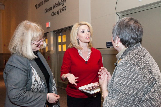 Linda Vaden-Goad, left, Framingham State University's vice president for academic affairs and Nancy Proulx, right, the school's director of professional and workforce development, greet Shonda Schilling, author of "The Best Kind of Different," a book about her son's struggle with Asperger's syndrome.