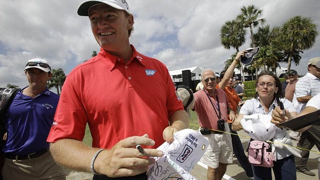 Jupiter resident Ernie Els signs autographs during a practice round before the WGC-Cadillac Championships on Wednesday, March 9, 2011, at Doral.