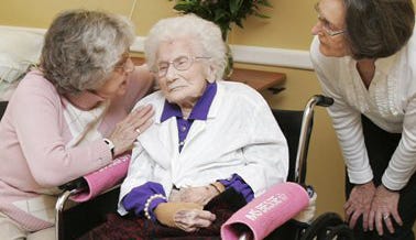 Besse Cooper, 114, sits in her wheelchair while daughter Angie Tharp, 82, left, and daughter-in-law Edith Cooper, 72, talk to her after a ceremony in which Guinness World Records recognized her as the word's oldest living person, at the nursing home where she lives, Thursday, March 10, 2011, in Monroe, Ga.