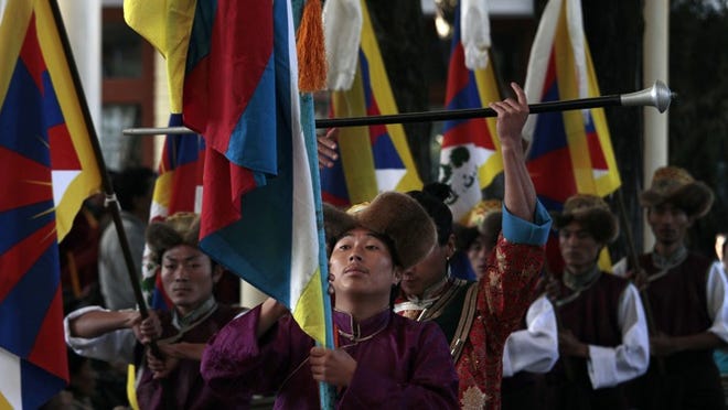 At the Tibetan government-in-exile's base in Dharmsala, India, Tibetan musicians perform Thursday to welcome the Dalai Lama, who is expected to propose his transfer of power next week.
