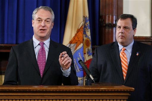 As New Jersey Gov. Chris Christie, right, looks on Thursday, New Jersey Education Commissioner Christopher Cerf answers a question about a task force report that Christie released on overhauling teacher evaluation.