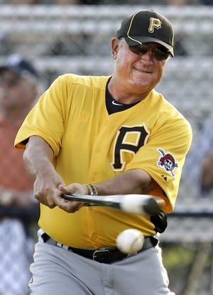 Clint Hurdle hits some fungoes during spring training.