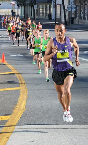 Defending champion Mo Trafeh of Duarte, Calif., begins to pull away from the men's field at the entrance to the Main Street Bridge early in the race. Trafeh finished 27 seconds ahead of runner-up Ben True.