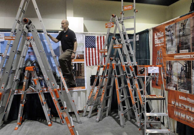 Theodore Cameron of Little Giant Solutions of Springville, Utah, displays ladders at the 2011 Spring Home Show last night at the DCU Center.