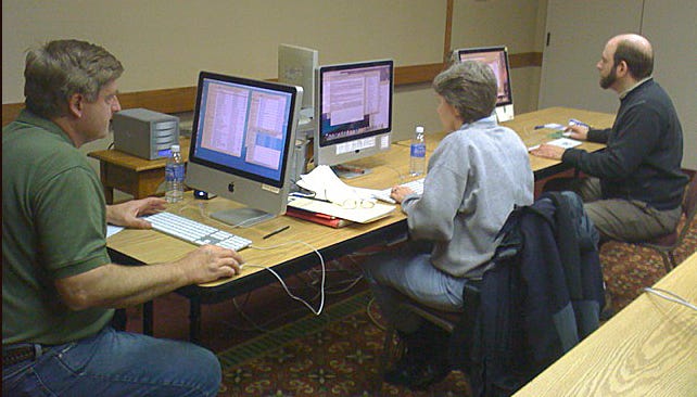 Daily Telegram systems manager Bruce Banks, community news writer Marge Furgason and news editor David Panian work Feb. 22 in the Telegram’s temporary newsroom at the Carlton Lodge in Adrian.