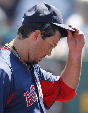 Josh Beckett walks to the dugout after being removed from the game during the fifth inning of the Red Sox' 9-4 loss to the Pittsburgh Pirates on Sunday in an exhibition game in Bradenton, Fla.