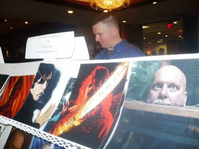 Jim Foye of New Haven, Conn., peruses film photos on Sunday at Monster Mania Con 17, at the Crowne Plaza in Cherry Hill.