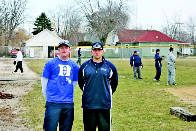 Monmouth-Roseville's new baseball coach (right) poses before practice with assistant coach Jimmy Jordan.