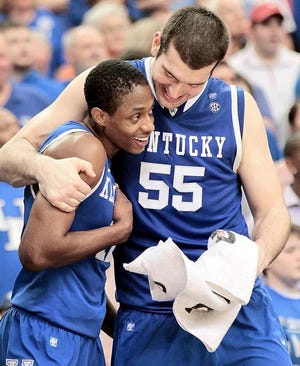Kentucky guard Brandon Knight, left, and forward Josh Harrellson embrace Sunday after defeating Florida 70-54 in the finals of the Southeastern Conference tournament. The Associated Press