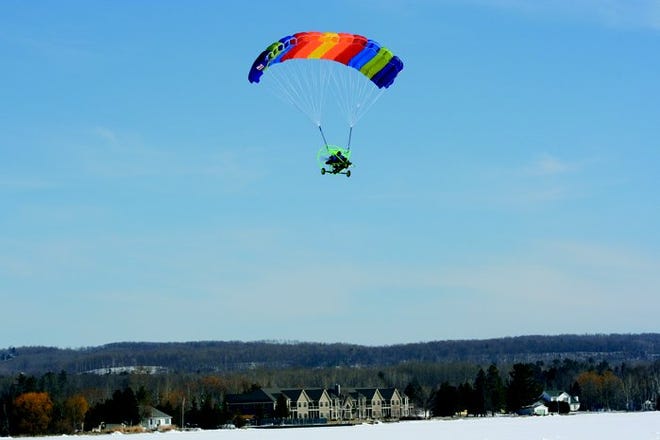 Monday's calm winds and clear skies made for perfect flying conditions for the pilot of this powered-parachute. Take-offs and landings were easily done at Crooked Lake near Conway.