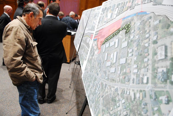 Resident Henry Martin studies maps of the rail yard during the Zoning Board of Appeals meeting last night.