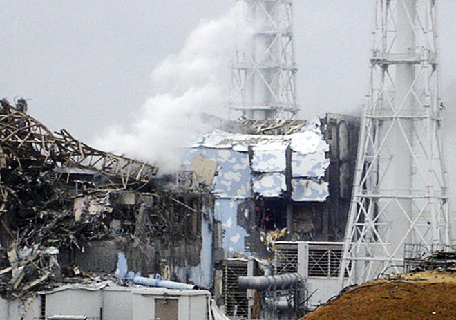 This image made available from Tokyo Electric Power Co. via Kyodo News, shows the damaged No. 4 unit of the Fukushima Dai-ichi nuclear complex in Okumamachi, northeastern Japan, on Tuesday March 15, 2011. White smoke billows from the No. 3 unit. (AP Photo/Tokyo Electric Power Co. via Kyodo News)