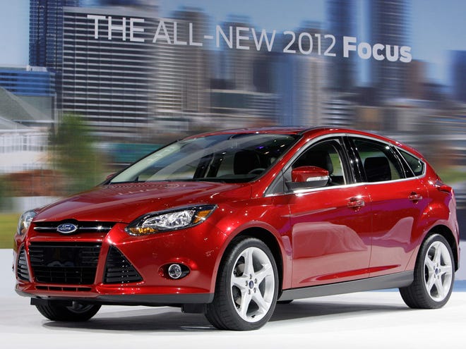 The 2012 Ford Focus is shown during its debut at the LA Auto Show in Los Angeles. The new compact gets 28 miles per gallon in city driving and 40 mpg on the highway. (AP)