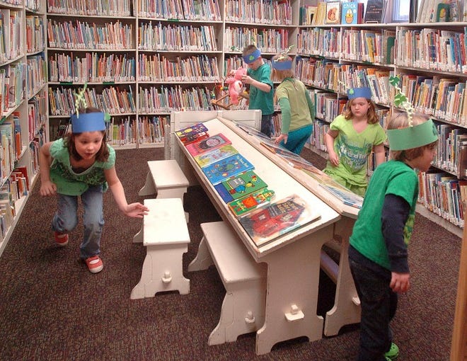 Looking for the pot o'gold in the Children's section inside the Riverton Library was the task of these children, Thursday afternoon during a craft event that had the children making St. Patrick's Day hats, dolls and enjoying green colored lemonade and donuts. BCT Photo N.Rokos
