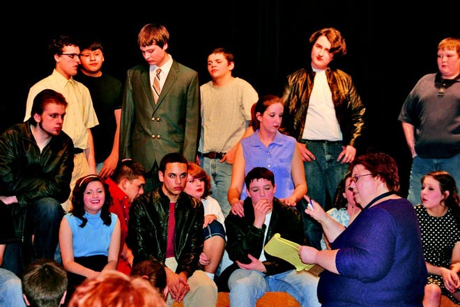 Director Melissa Agar critiques and gives guidance to the cast and crew of the Monmouth-Roseville High School production of "Grease" during a "halftime" break at rehearsals Tuesday night in the auditorium at the high school.