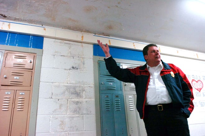 East Bridgewater Fire Chief Ryon Pratt, co-chairman of the High School Building Committee, shows where the water leaks enter the school on the third floor during a tour of the facility on Tuesday, Feb. 8, 2011.