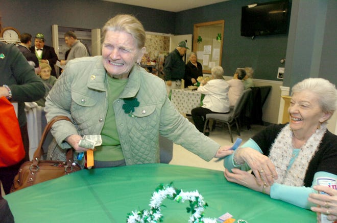 Dorothy DelVendo of Abington, left, greets her friend Fran Silvia of Rockland at Tuesday's St. Patrick's Day luncheon for seniors.