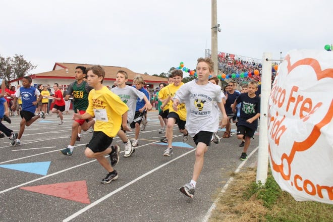 With fans in the stands cheering them on, Clay County elementary school students take off in the mile run at the annual Breathe Easy Track and Field Invitational, held at Middleburg High School and featuring nearly 3,000 participants.
