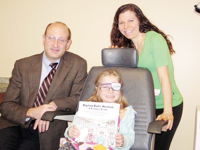 Opthalmologist Dr.Gary Markowitz (left), eye doctor for Rachel Bennett (center), provided scientific information for local author Donna Bennett's newest children's book .