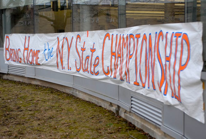 A banner hanging across the front of the New York Mills Central School building, Wednesday, March 16, 2011 in New York Mills. The boys basketball team will be playing int he Class D state final four in Glens Falls.