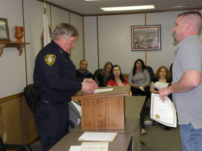 Josh Wiley, one of the 12 graduates of the Aledo Police Department Citizens Academy receives his certificate from APD interim Chief Terry Dove.